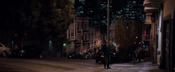 Movie still from “Venom” (2018), directed by Ruben Fleischer – A man standing on the side of the street at night; Extreme Wide shot, High angle