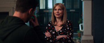 Movie still from “Venom” (2018), directed by Ruben Fleischer – A woman sitting in front of a man in front of a window; Medium shot, Over the shoulder angle