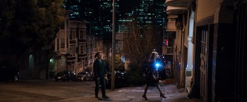 Movie still from “Venom” (2018), directed by Ruben Fleischer – A man and a woman walking down a street at night; Extreme Wide shot, High angle