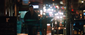 Movie still from “Venom” (2018), directed by Ruben Fleischer – A man standing in the middle of a street at night; Wide shot, Low angle