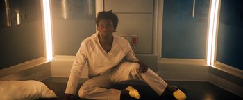 Movie still from “Venom” (2018), directed by Ruben Fleischer – A man sitting on the floor next to a banana peel; Medium shot, Low angle