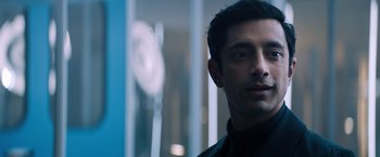 Movie still from “Venom” (2018), directed by Ruben Fleischer – A person wearing a black shirt; Close Up shot, Over the shoulder angle