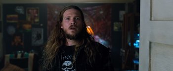 Movie still from “Venom” (2018), directed by Ruben Fleischer – A man with long hair is looking up; Close Up shot, Over the shoulder angle