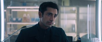 Movie still from “Venom” (2018), directed by Ruben Fleischer – A person wearing a jacket; Close Up shot, Over the shoulder angle