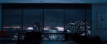Movie still from “Venom” (2018), directed by Ruben Fleischer – A view of a city at night through a window; Extreme Wide shot, High angle