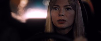 Movie still from “Venom” (2018), directed by Ruben Fleischer – A woman sitting in a car with her eyes wide open; Close Up shot, Over the shoulder angle