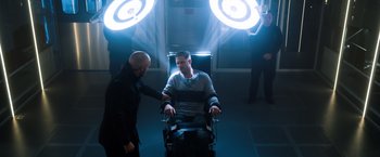Movie still from “Venom” (2018), directed by Ruben Fleischer – A man sitting in a chair in a room with two lights; Medium shot, Over the shoulder angle