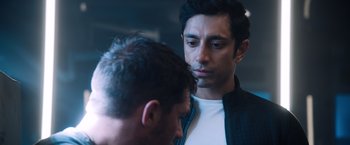 Movie still from “Venom” (2018), directed by Ruben Fleischer – Two men standing next to each other looking at each other; Close Up shot, Over the shoulder angle