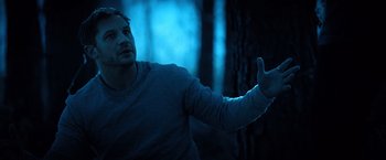 Movie still from “Venom” (2018), directed by Ruben Fleischer – A man in a gray shirt is pointing his finger at something; Medium shot, Low angle