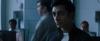 Movie still from “Venom” (2018), directed by Ruben Fleischer – A man in a black jacket is looking at the camera; Close Up shot, Over the shoulder angle