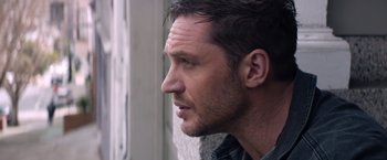 Movie still from “Venom” (2018), directed by Ruben Fleischer – A man's face looking out a window; Close Up shot, Over the shoulder angle