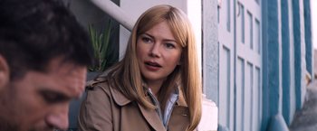 Movie still from “Venom” (2018), directed by Ruben Fleischer – A woman with long blonde hair wearing a trench coat; Close Up shot, Over the shoulder angle
