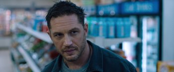 Movie still from “Venom” (2018), directed by Ruben Fleischer – A person wearing a jacket; Close Up shot, Over the shoulder angle
