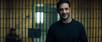 Movie still from “Venom” (2018), directed by Ruben Fleischer – A man standing in front of a metal gate; Close Up shot, Over the shoulder angle