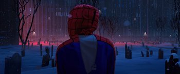 Movie still from “Venom” (2018), directed by Ruben Fleischer – A man wearing a spider - man costume standing in the snow; Medium shot, Over the shoulder angle