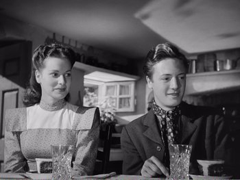 Movie still from “How Green Was My Valley” (1941), directed by John Ford – A man and a woman sitting at a dinner table; Medium shot, Low angle