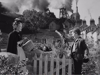 Movie still from “How Green Was My Valley” (1941), directed by John Ford – A black and white photo of a woman and a boy; Wide shot, High angle