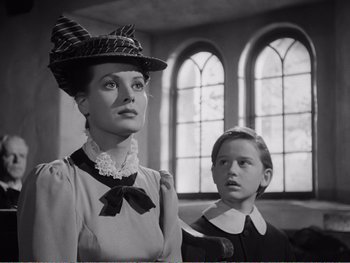 Movie still from “How Green Was My Valley” (1941), directed by John Ford – A woman and a boy in a black and white photo; Medium shot, Low angle