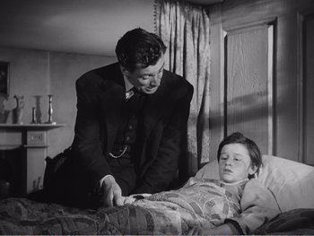 Movie still from “How Green Was My Valley” (1941), directed by John Ford – An old black and white photo of a man and a young boy; Medium shot, Low angle