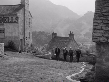 Movie still from “How Green Was My Valley” (1941), directed by John Ford – A group of people walking down a street; Extreme Wide shot, Low angle