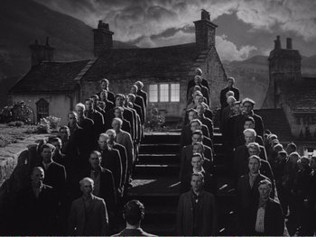 Movie still from “How Green Was My Valley” (1941), directed by John Ford – A group of people standing in front of a building; Extreme Wide shot, High angle