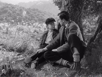 Movie still from “How Green Was My Valley” (1941), directed by John Ford – A couple of men sitting next to each other on the ground; Medium shot, High angle
