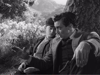 Movie still from “How Green Was My Valley” (1941), directed by John Ford – Two men sitting next to each other on the ground; Medium shot, High angle