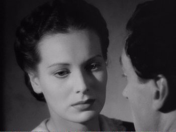 Movie still from “How Green Was My Valley” (1941), directed by John Ford – A black - and - white photo of a woman looking at another woman; Close Up shot, Over the shoulder angle