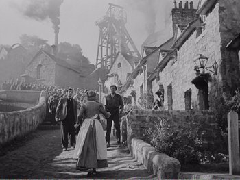 Movie still from “How Green Was My Valley” (1941), directed by John Ford – A black and white photo of people walking down a street; Extreme Wide shot, High angle