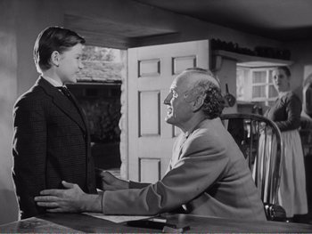 Movie still from “How Green Was My Valley” (1941), directed by John Ford – An older man and a young woman shaking hands; Medium shot, Over the shoulder angle