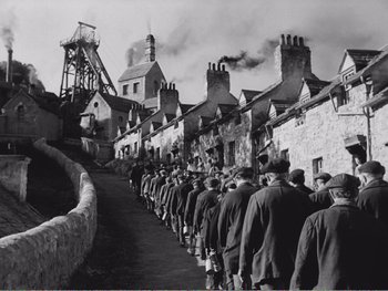 Movie still from “How Green Was My Valley” (1941), directed by John Ford – A group of men standing in a row on the side of a road; Extreme Wide shot, High angle