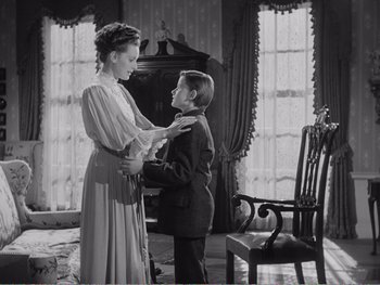 Movie still from “How Green Was My Valley” (1941), directed by John Ford – An old photo of a woman and a young boy; Medium shot, High angle