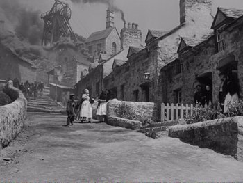 Movie still from “How Green Was My Valley” (1941), directed by John Ford – A black and white photo of people walking down a street; Extreme Wide shot, High angle