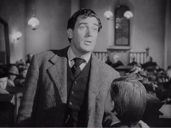 Movie still from “How Green Was My Valley” (1941), directed by John Ford – A black and white photo of a man and a boy; Medium shot, Low angle