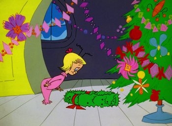 Movie still from “How the Grinch Stole Christmas!” (1966), directed by Ben Washam – A girl in a pink dress looking at a christmas wreath; Medium shot, High angle