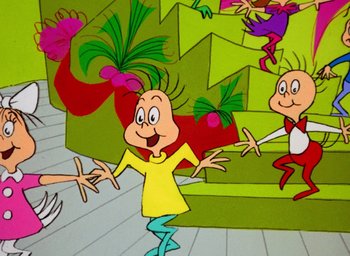 Movie still from “How the Grinch Stole Christmas!” (1966), directed by Ben Washam – A group of people standing next to each other on the ground; Medium shot, Low angle