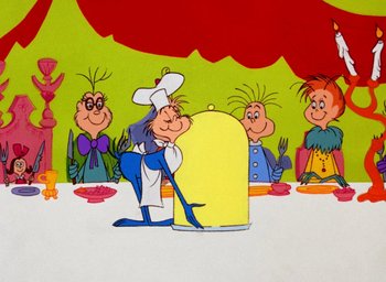 Movie still from “How the Grinch Stole Christmas!” (1966), directed by Ben Washam – A group of people sitting at a table with food; Medium shot, Over the shoulder angle