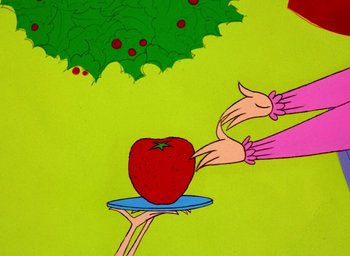 Movie still from “How the Grinch Stole Christmas!” (1966), directed by Ben Washam – An apple being held on a plate by two hands; Extreme Close Up shot, Overhead angle