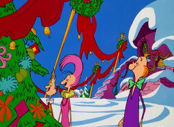 Movie still from “How the Grinch Stole Christmas!” (1966), directed by Ben Washam – A group of people standing next to each other in the snow; Extreme Wide shot, Low angle
