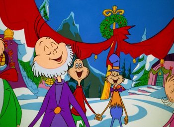 Movie still from “How the Grinch Stole Christmas!” (1966), directed by Ben Washam – A group of people standing next to each other in the snow; Medium shot, Low angle