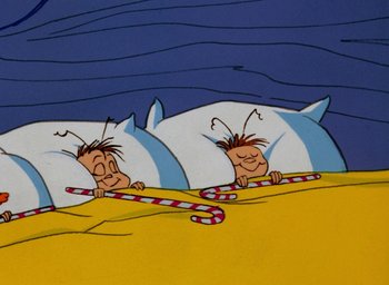 Movie still from “How the Grinch Stole Christmas!” (1966), directed by Ben Washam – A cartoon of two people sleeping on a bed; Medium shot, Overhead angle