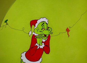 Movie still from “How the Grinch Stole Christmas!” (1966), directed by Ben Washam – A painting of the grinch in a santa suit; Close Up shot, Low angle