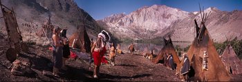 Movie still from “How the West Was Won” (1962), directed by George Marshall – A group of native american men standing next to each other; Wide shot, High angle
