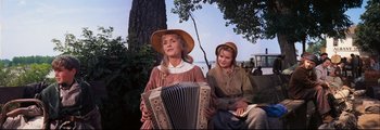 Movie still from “How the West Was Won” (1962), directed by George Marshall – Two women sitting next to each other in front of a tree; Medium shot, Low angle