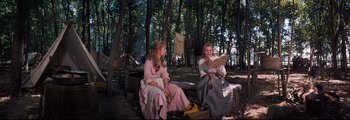 Movie still from “How the West Was Won” (1962), directed by George Marshall – Two women sitting on a bench in the woods; Wide shot, Over the shoulder angle
