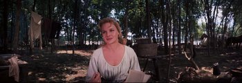 Movie still from “How the West Was Won” (1962), directed by George Marshall – A beautiful woman holding a pen and a book; Medium shot, High angle