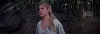 Movie still from “How the West Was Won” (1962), directed by George Marshall – A woman with long blonde hair wearing a white dress; Close Up shot, Low angle