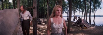 Movie still from “How the West Was Won” (1962), directed by George Marshall – A woman standing in the woods near a body of water; Medium shot, Low angle