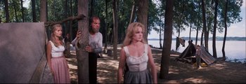 Movie still from “How the West Was Won” (1962), directed by George Marshall – A man and a woman standing next to a tree; Medium shot, Over the shoulder angle
