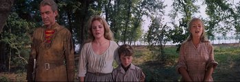 Movie still from “How the West Was Won” (1962), directed by George Marshall – A woman standing next to a young boy in a forest; Medium shot, Low angle